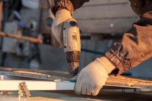 Picture of someone installing siding.