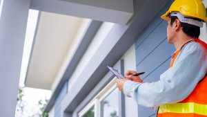 Inspector checking the roof of a house