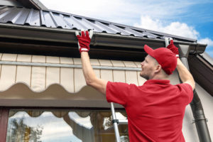 Technician inspects an asphalt shingle roof